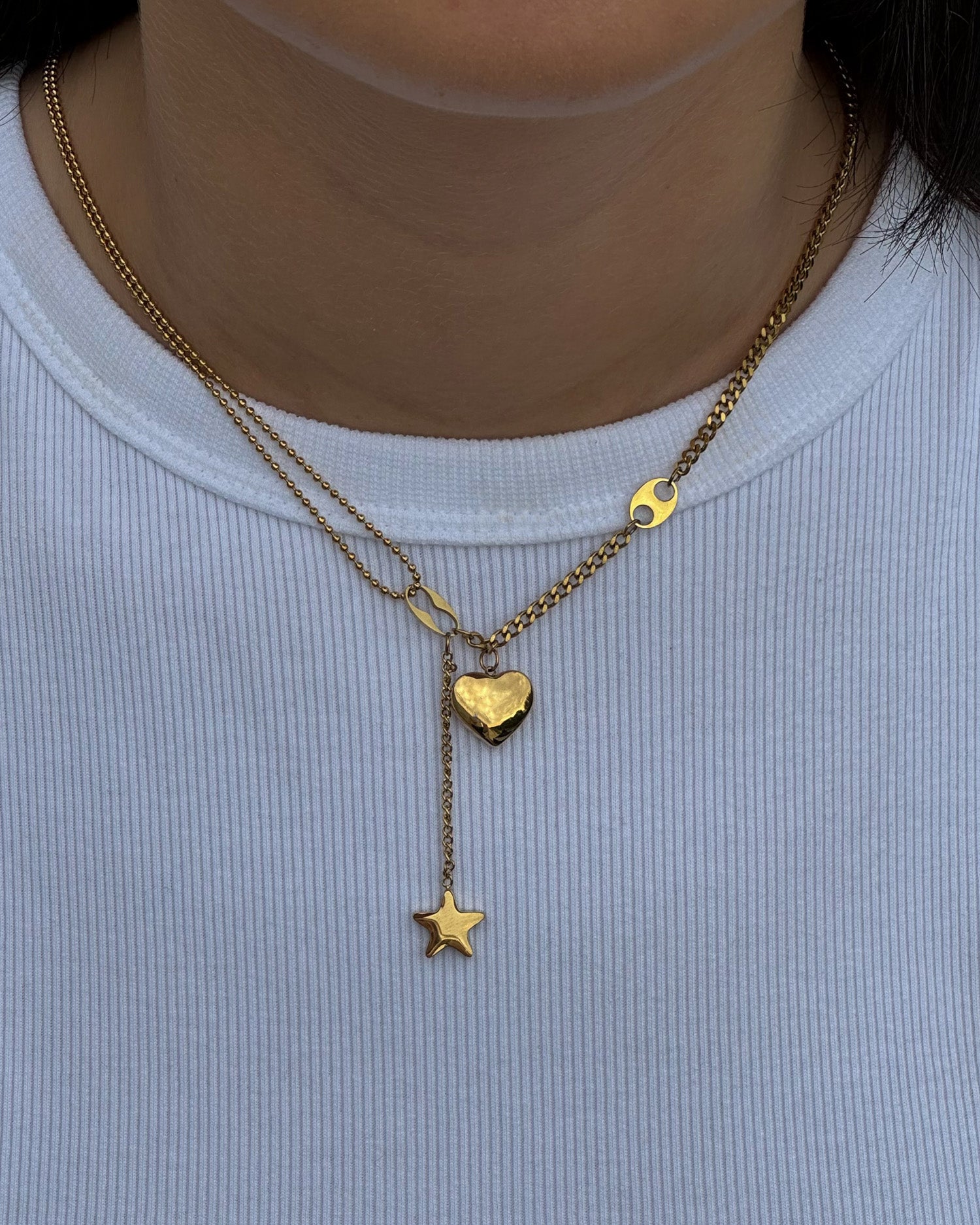 Necklace with a heart and star pendants