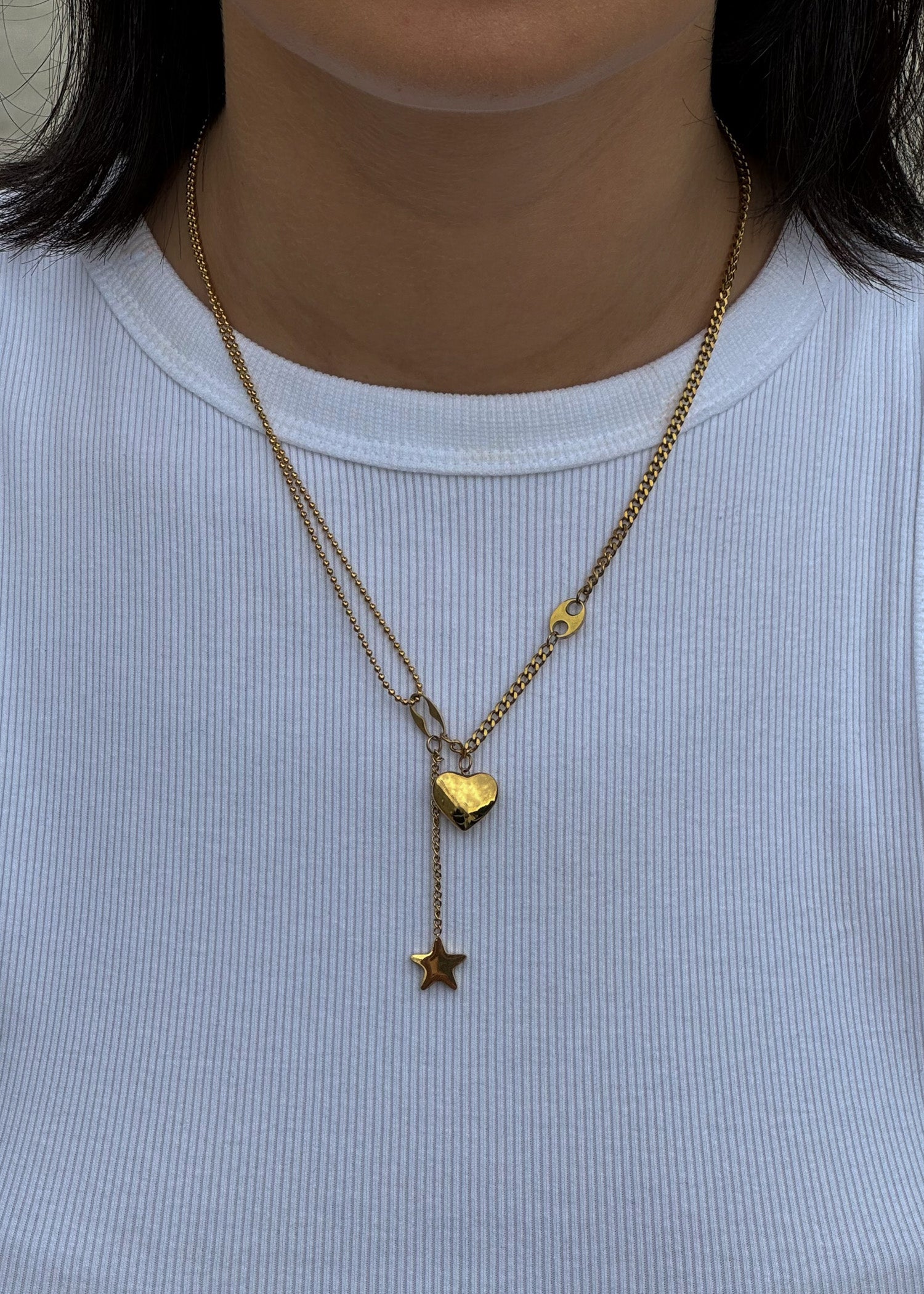 Necklace with a heart and star pendants